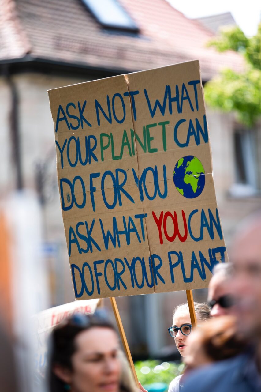 Placard reading 'ask not what your planet can do for you, ask what you can do for your planet'