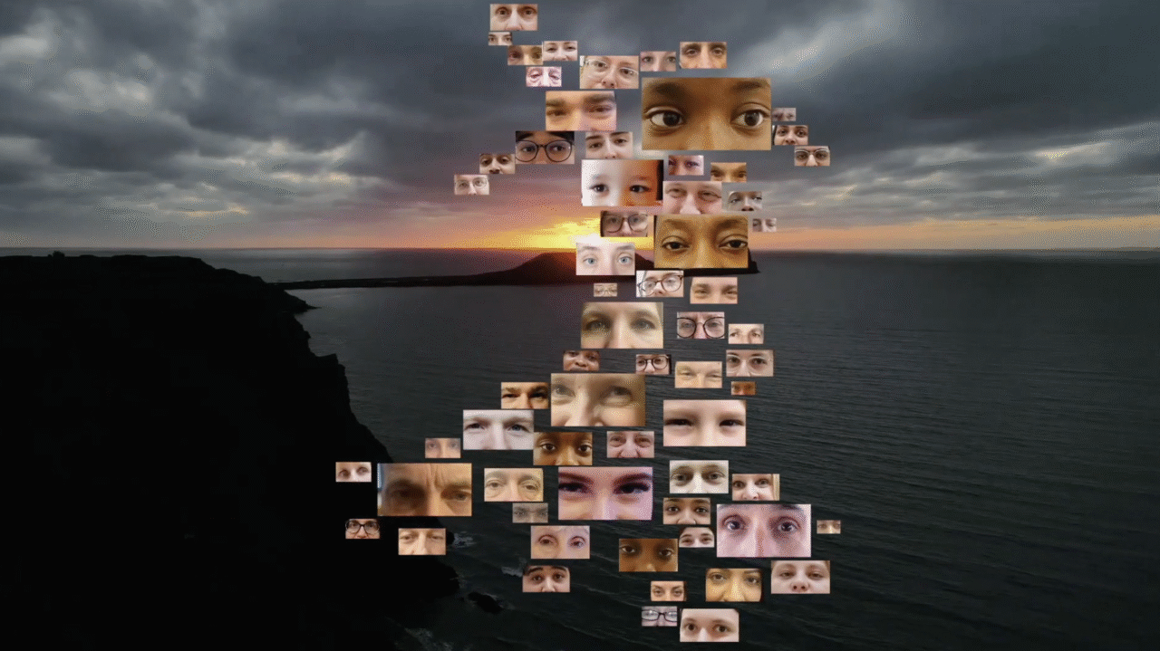 Map of Wales made up of images of peoples eyes. Sunset over the Welsh coast in the background.