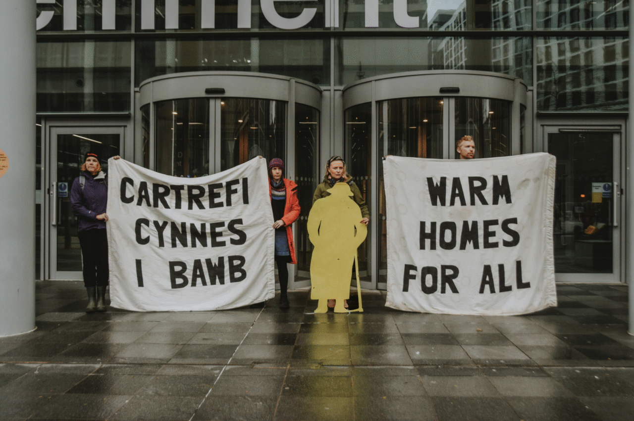 Climate Cymru campaigns for Warm Homes For All outside the UK government offices in Cardiff, Wales.